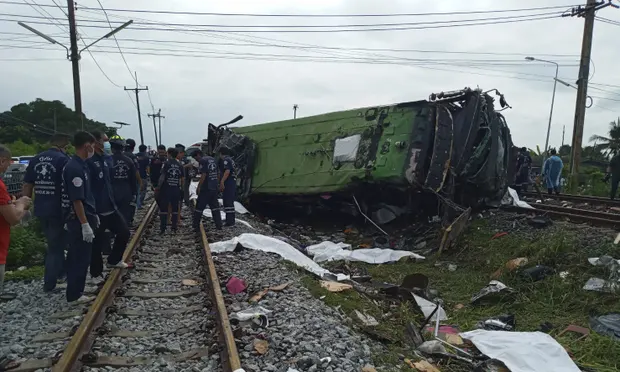 Thailand bus crash: at least 17 killed in collision with train